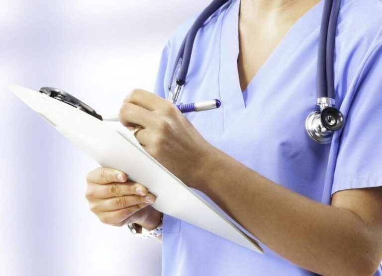 Nurse filling out documents.